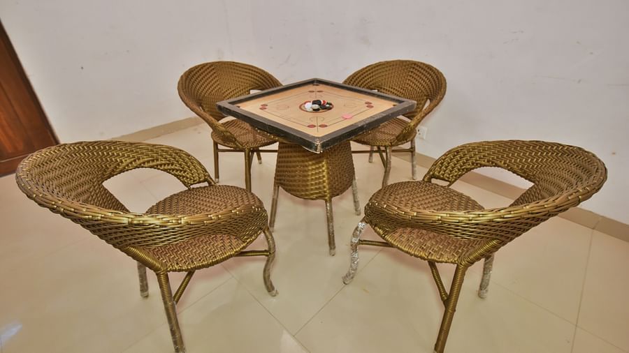 A carrom board placed on a table surrounded by four chairs at DLS Highland Resort and Spa, Mussoorie.